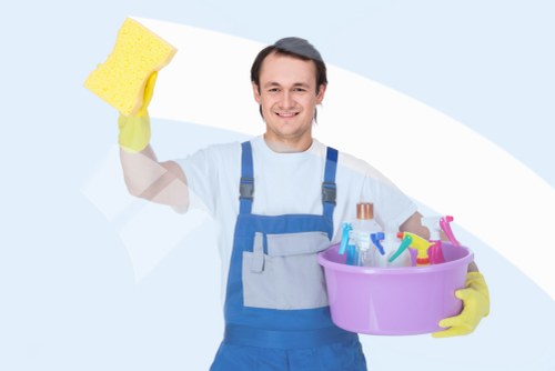 Cleaner wearing PPE while operating carpet cleaning equipment